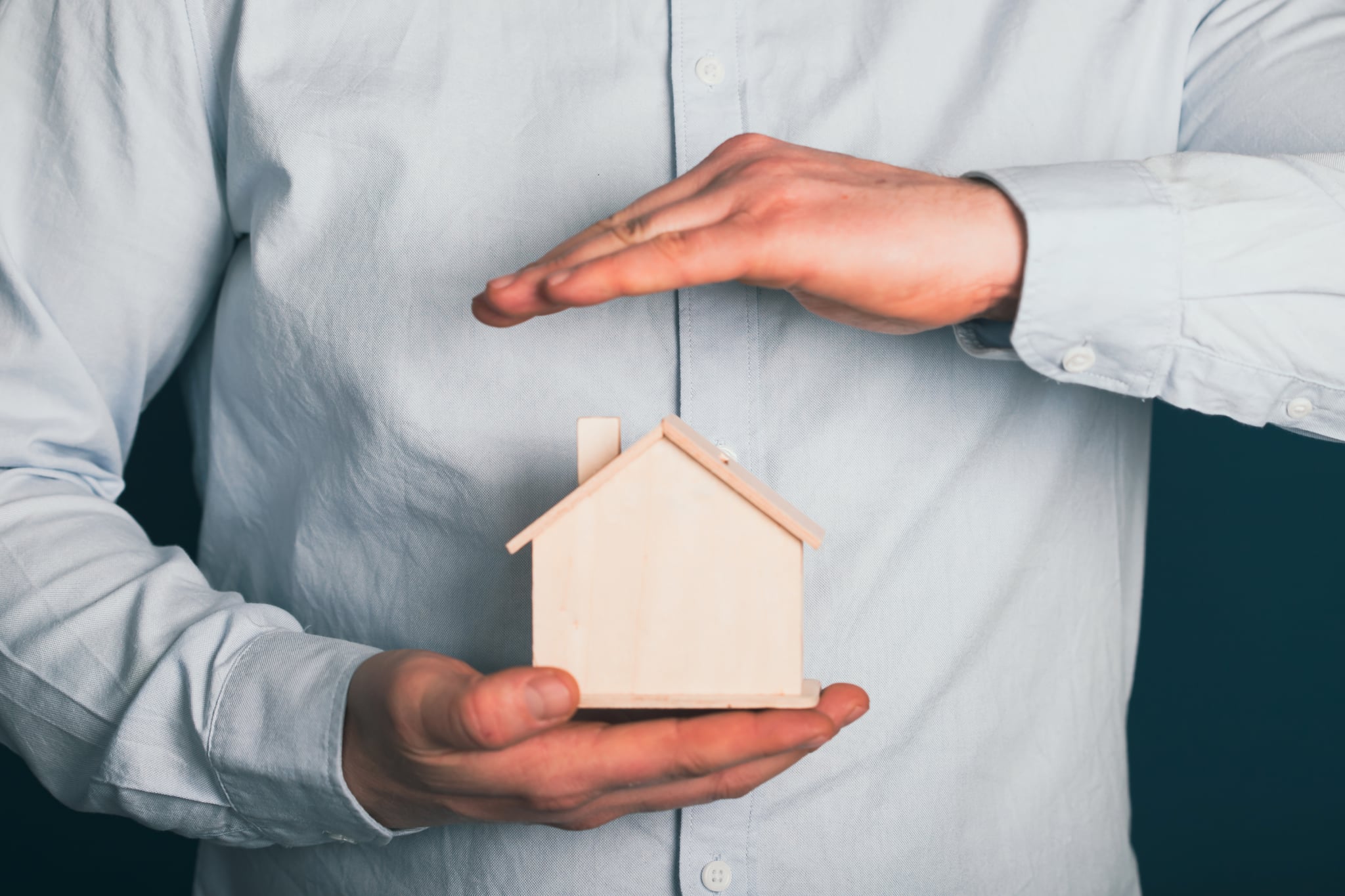 A small home model protected by careful hands